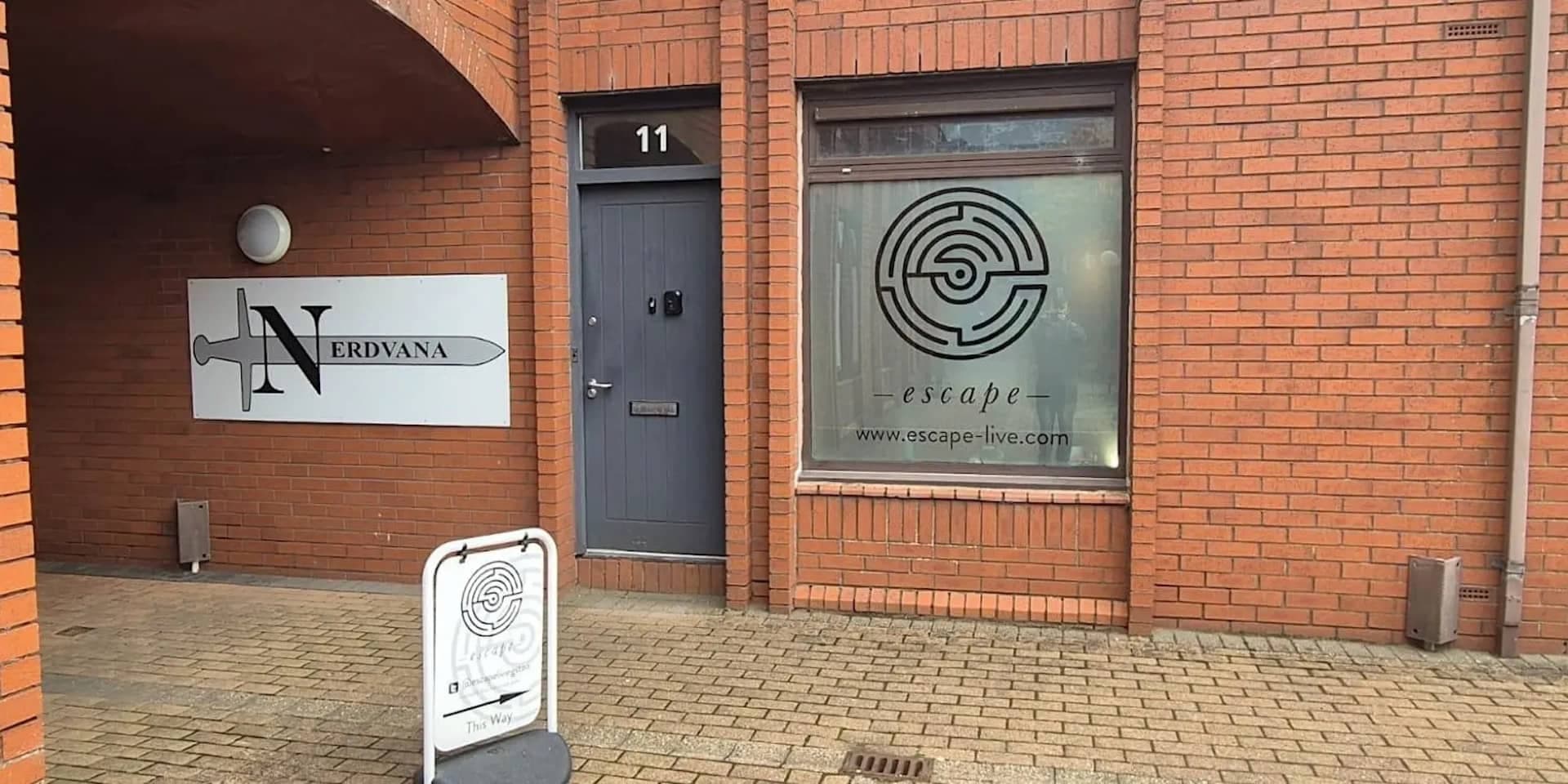 Exterior of the Nerdvana Livingston Unit 11 entrance with the Nerdvana logo sign